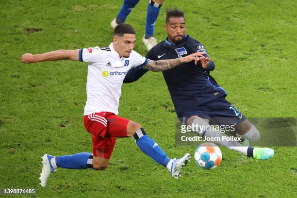 Kevin-Prince Boateng of Hertha Berlin challenges Ludovit Reis of Hamburger SV during the Bundesliga Playoffs Leg Two match between Hamburger SV and...