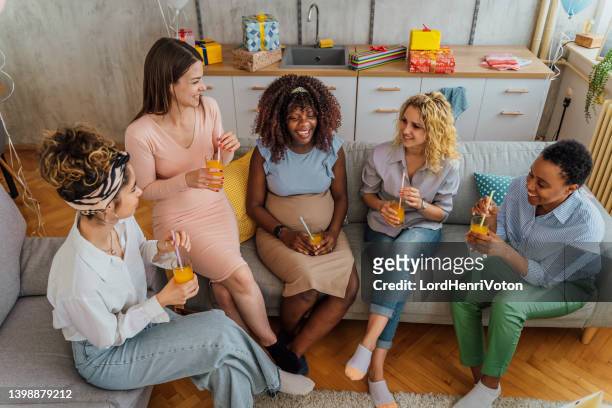 diverse women together at baby shower - babyshower stockfoto's en -beelden