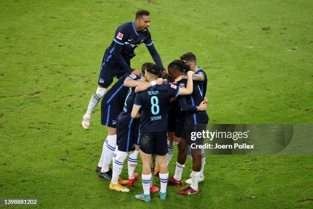 Kevin-Prince Boateng of Hertha Berlin jumps on top as players of Hertha Berlin celebrate their team's second goal scored by Marvin Plattenhardt...