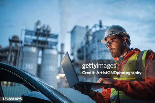Dedicated engineer working until the late hours in the oil and gas industry with laptop. Dedicated engineer working until the late hours in the oil and gas industry with laptop.