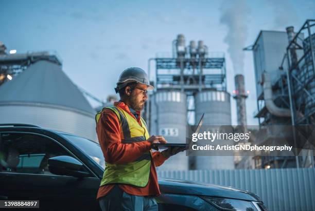 hard working engineer on the power station with laptop. - nuclear energy worker stock pictures, royalty-free photos & images