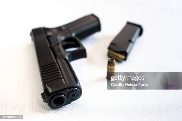 close-up of a pistol seen from the front - handgun stock pictures, royalty-free photos & images