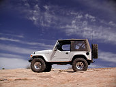 Jeep Wrangler on top of a sand dune