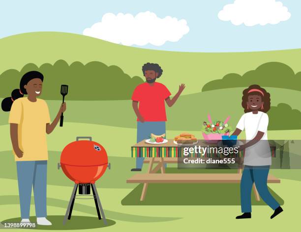 family celebrating juneteenth - picnic table stock illustrations