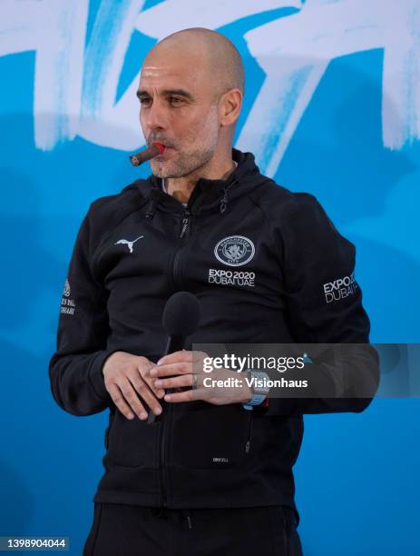 Manchester City manager Pep Guardiola smoking a cigar during the Manchester City FC Victory Parade on May 23, 2022 in Manchester, England.