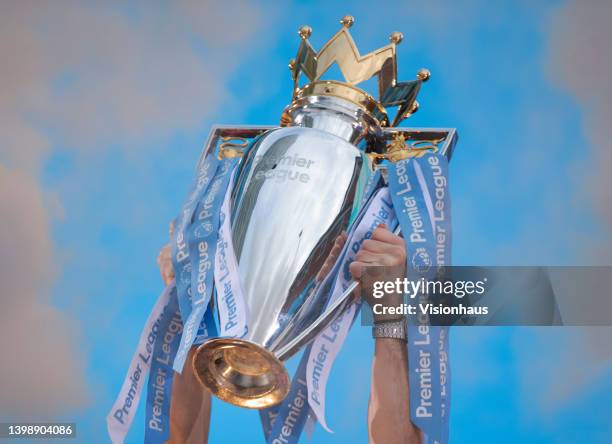 The Premier League trophy is held aloft during the Manchester City FC Victory Parade on May 23, 2022 in Manchester, England.