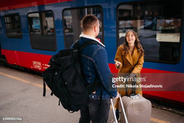 beautiful couple hugging after long journey - long distance relationship stockfoto's en -beelden