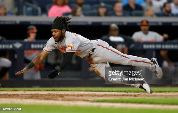 Cedric Mullins of the Baltimore Orioles dives home for a run in the third inning against the New York Yankees at Yankee Stadium on May 23, 2022 in...
