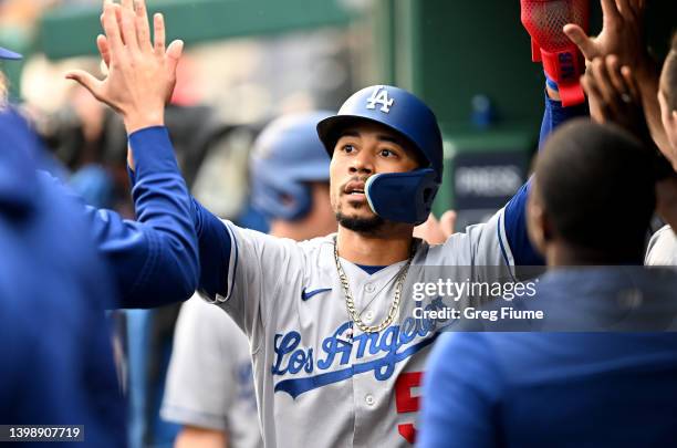 Mookie Betts of the Los Angeles Dodgers celebrates with teammates after scoring in the first inning against the Washington Nationals at Nationals...