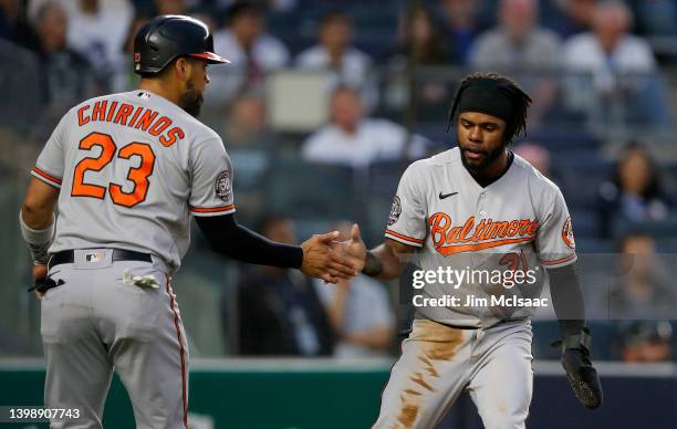 Cedric Mullins and Robinson Chirinos of the Baltimore Orioles celebrate after both scored in the third inning against the New York Yankees at Yankee...