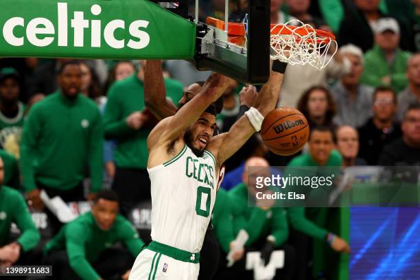 Jayson Tatum of the Boston Celtics dunks the ball against Bam Adebayo of the Miami Heat during the first quarter in Game Four of the 2022 NBA...