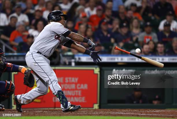 Jose Ramirez of the Cleveland Guardians fouls off a pitch, losing his bat in the process against the Houston Astros in the third inning at Minute...