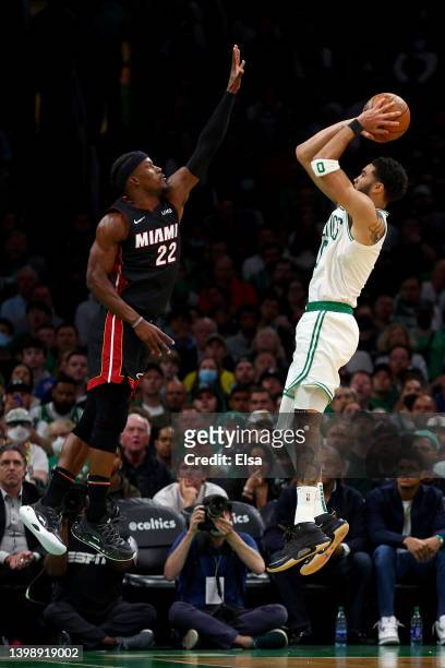 Jayson Tatum of the Boston Celtics shoots the ball against Jimmy Butler of the Miami Heat during the third quarter in Game Four of the 2022 NBA...