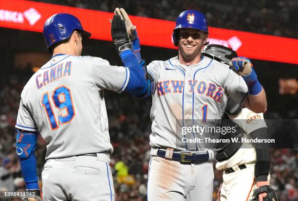 Jeff McNeil of the New York Mets is congratulated by Mark Canha after hitting a two-run home run against the San Francisco Giants in the top of the...