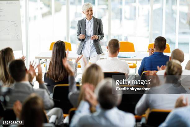 successful business presentation! - applauding leader stock pictures, royalty-free photos & images