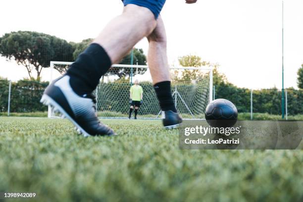 football player about to kick a penalty - soccer close up stockfoto's en -beelden