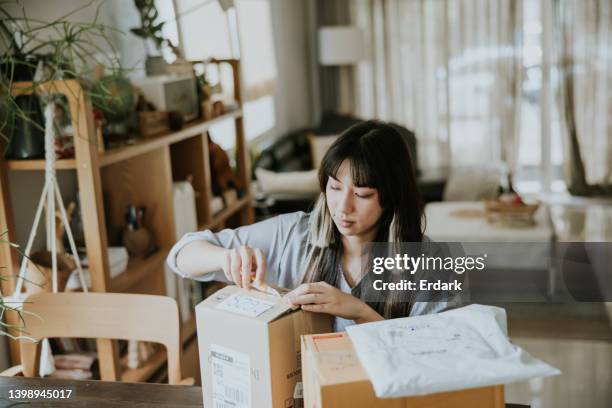 unpacking parcel post, shopping online box. - online shopping opening package stock pictures, royalty-free photos & images