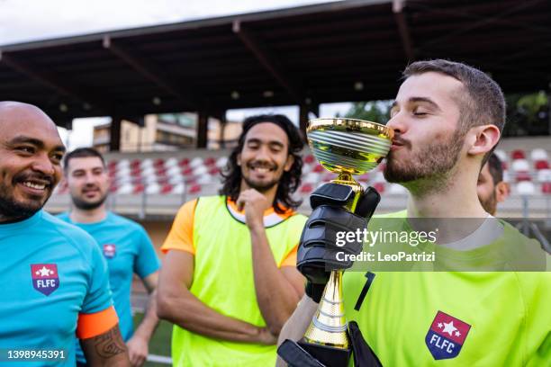 soccer team celebrates victory of the tournament - mate kiss stock pictures, royalty-free photos & images