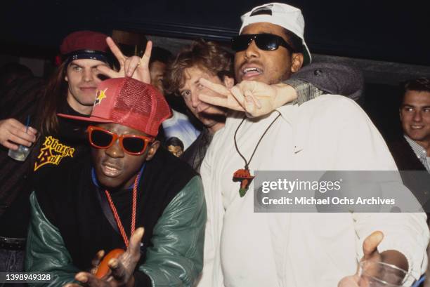 American rapper Flavor Flav, wearing a red baseball cap and red-framed sunglasses, of Public Enemy with American rapper Tone Loc, wearing a white...