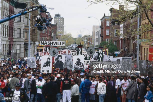 Public Enemy during the film of the music video for their single 'Fight the Power' in the Brooklyn borough of New York City, New York, 22nd April...