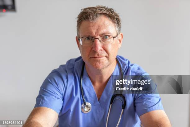 portrait of a doctor in surgical scrubs - doctor scrubs stock pictures, royalty-free photos & images