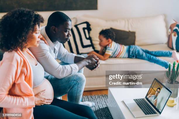 pregnant woman meeting with her doctor online - telemedicine choicepix stock pictures, royalty-free photos & images