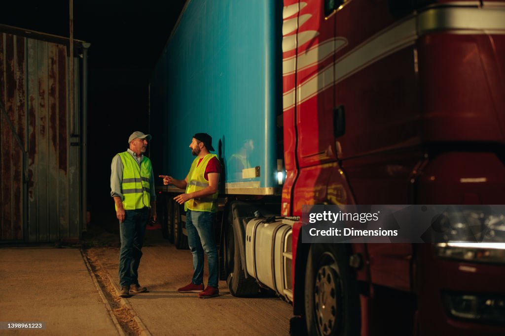 Drivers Break Two Truck Drivers Taking A Break And Hanging High-Res Stock Photo ...