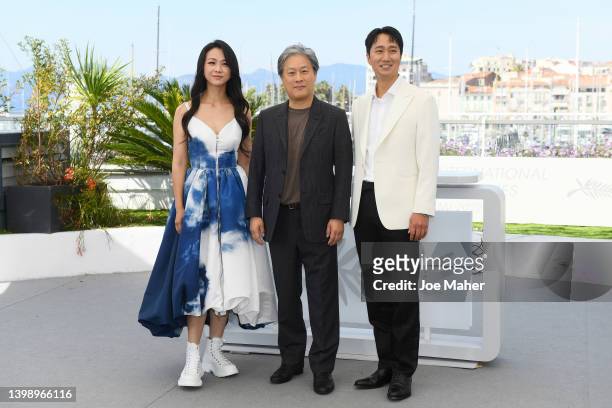 Tang Wei, Director Park Chan-wook and Park Hae-il attend the photocall for "Decision To Leave " during the 75th annual Cannes film festival at Palais...