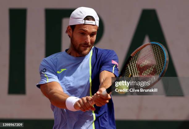 Joao Sousa of Portugal plays a backhand against Chun-Hsin Tseng of Chinese Taipei during the Men's Singles First Round match on Day 3 of the French...