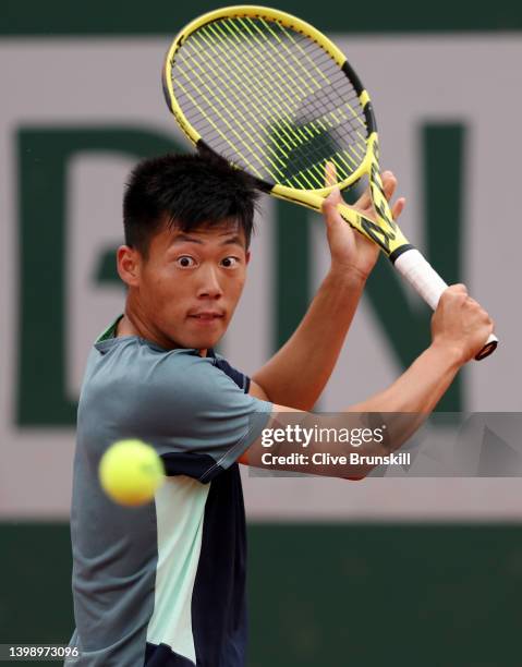 Chun-Hsin Tseng of Chinese Taipei plays a backhand against Joao Sousa of Portugal during the Men's Singles First Round match on Day 3 of the French...