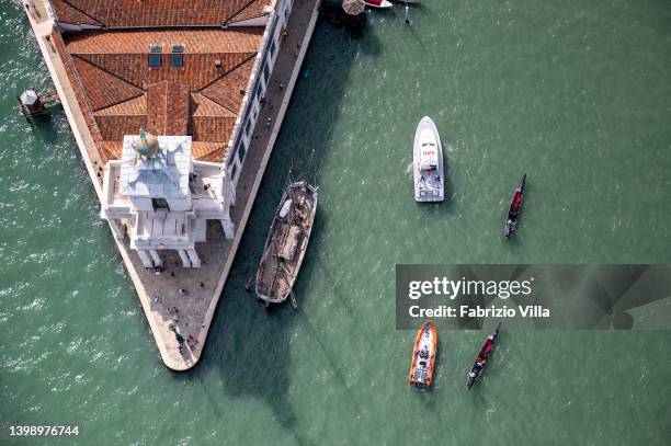 Aerial view, from a helicopter, of Punta della Dogana or Punta della Salute is an area of Venice, a thin triangular point dividing the Grand Canal...