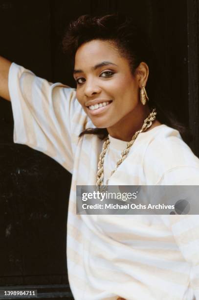 American DJ Spinderella of American hip hop band Salt-n-Pepa, wearing a white-and-peach striped t-shirt and a thick gold chain, United States, circa...