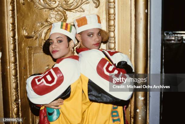 American hip hop band Salt-n-Pepa , both wearing kente kufi hats and leather baseball jackets, posing back-to-back, both with their arms folded,...