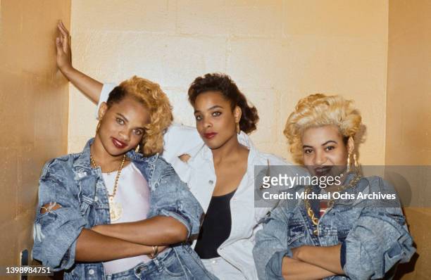American hip hop band Salt-n-Pepa , with Pepa and Salt wearing denim jackets with their arms folded, in a studio portrait, United States, circa 1990.