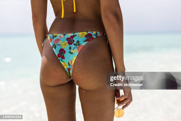 unrecognizable woman's buttocks in bikini on the beach. - beach bum stock pictures, royalty-free photos & images