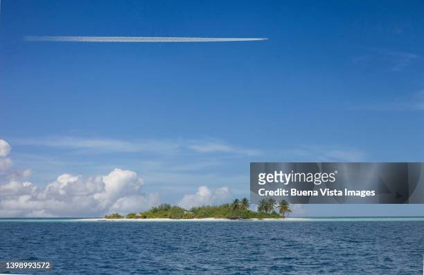 airplane flying over a tropical island. - list of islands by highest point stock pictures, royalty-free photos & images