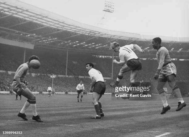 Bobby Smith looks on as Bobby Charlton, Forward for England jumps to head the ball towards the Brazilian team goal during the FA International...