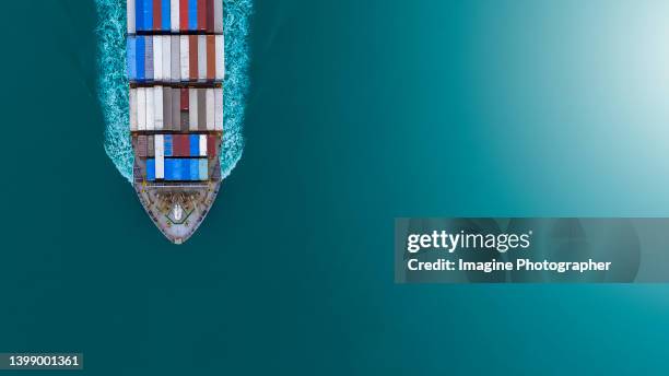 aerial top view, large container ship ( container ship prow ) sailing hi- speed in the blue sea. about the business of import, export, logistics and international shipping by container ships. - cargo containers stock pictures, royalty-free photos & images