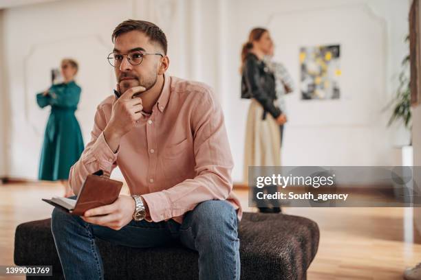 man in art gallery - criticus stock pictures, royalty-free photos & images