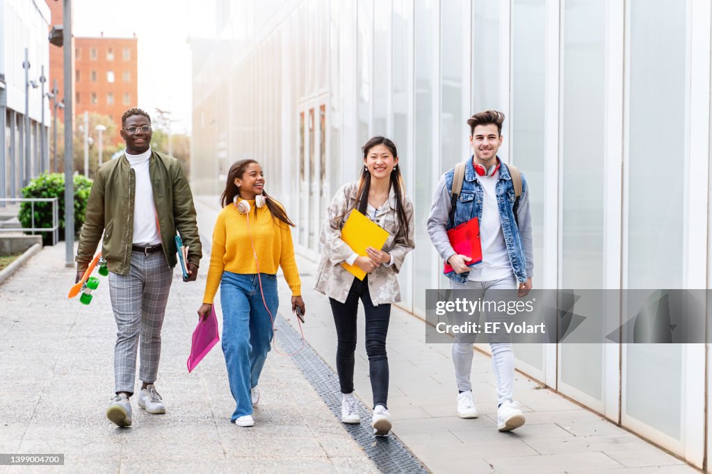 Group of Happy University Students with Backpacks and books Walking to School
