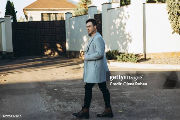 young man walk by mansion. - special jurisdiction for peace stock pictures, royalty-free photos & images