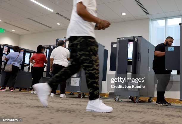 People use voting machines to fill out their ballots as they vote in the Georgia primary at the Metropolitan Library on May 24, 2022 in Atlanta,...