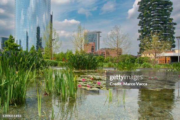 coexistence of nature and industry,biblioteca degli alberi park - bosco verticale milano stock pictures, royalty-free photos & images