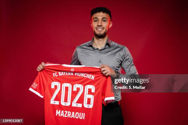 Newly signed player of FC Bayern Muenchen, Noussair Mazraoui, poses with a jersey after his contract signing at Saebener Strasse training ground on...