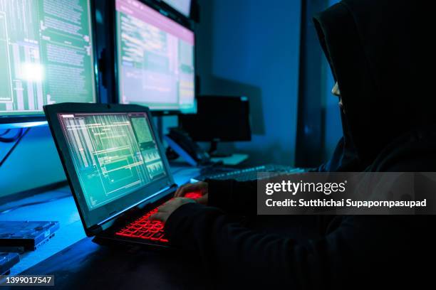 the woman wear the black mask attacking the internet in the dark room with multiple monitor. - dark web stock pictures, royalty-free photos & images
