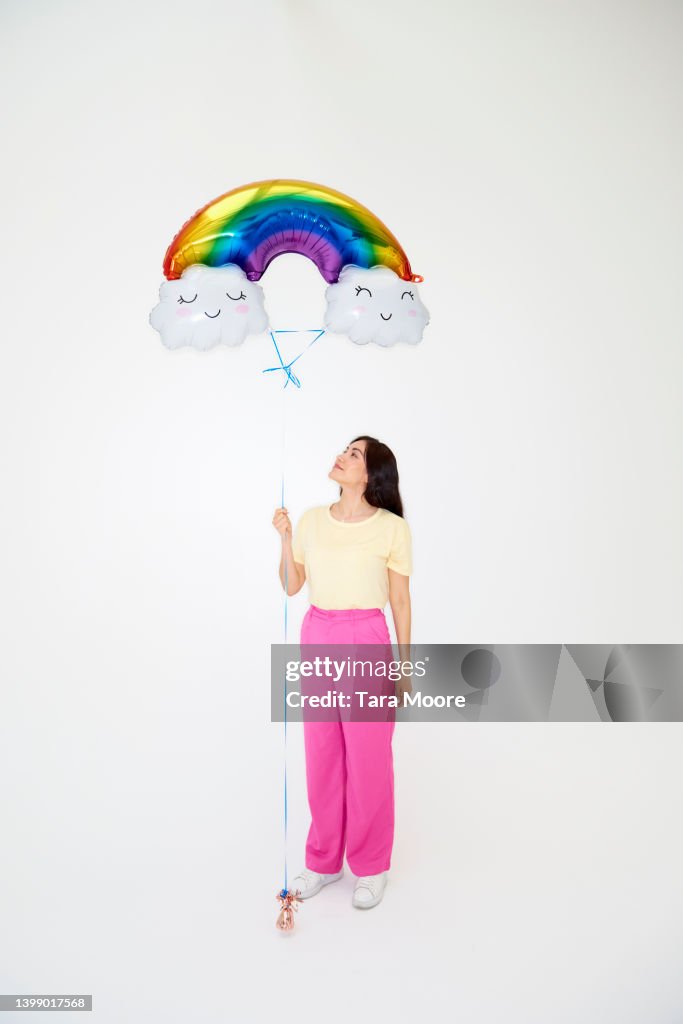 Woman holding rainbow balloon