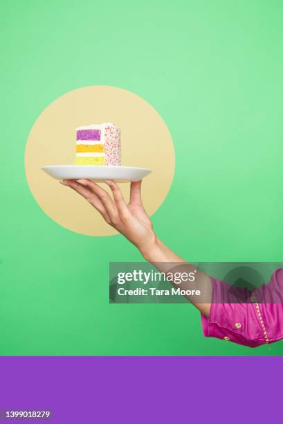 hand holding cake - temptation stock pictures, royalty-free photos & images