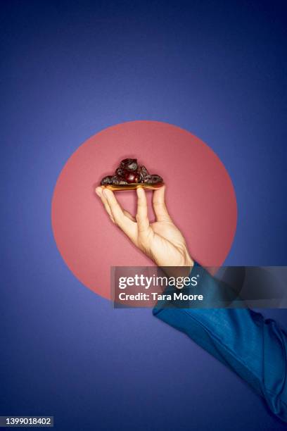 hands and tray of dates - middle east food stock pictures, royalty-free photos & images