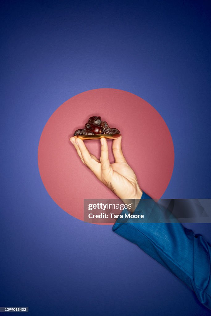 Hands and tray of dates