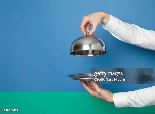 hands holding silver tray and lid - plate in hand stockfoto's en -beelden